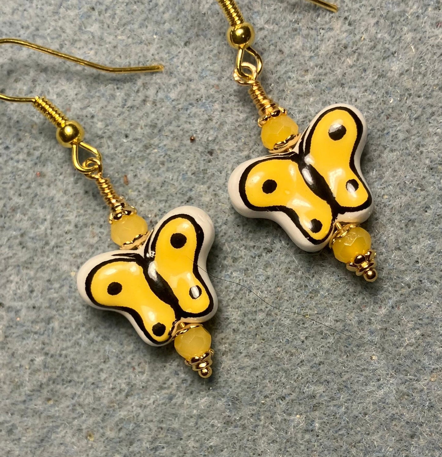 Yellow and black ceramic butterfly bead earrings adorned with yellow Chinese crystal beads.