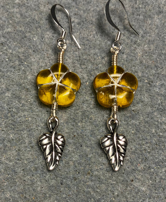 Yellow (with silver inlay) Czech glass puffy flower bead earrings adorned with silver Tierracast leaf charms.
