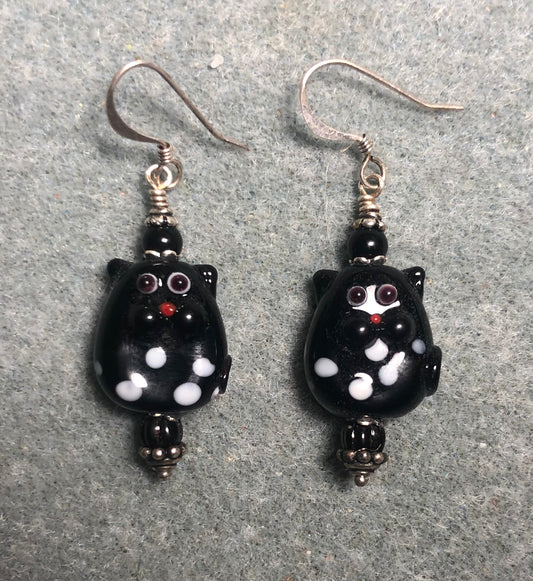 Small black lamp work polka dot cat bead earrings adorned with black Czech glass beads.