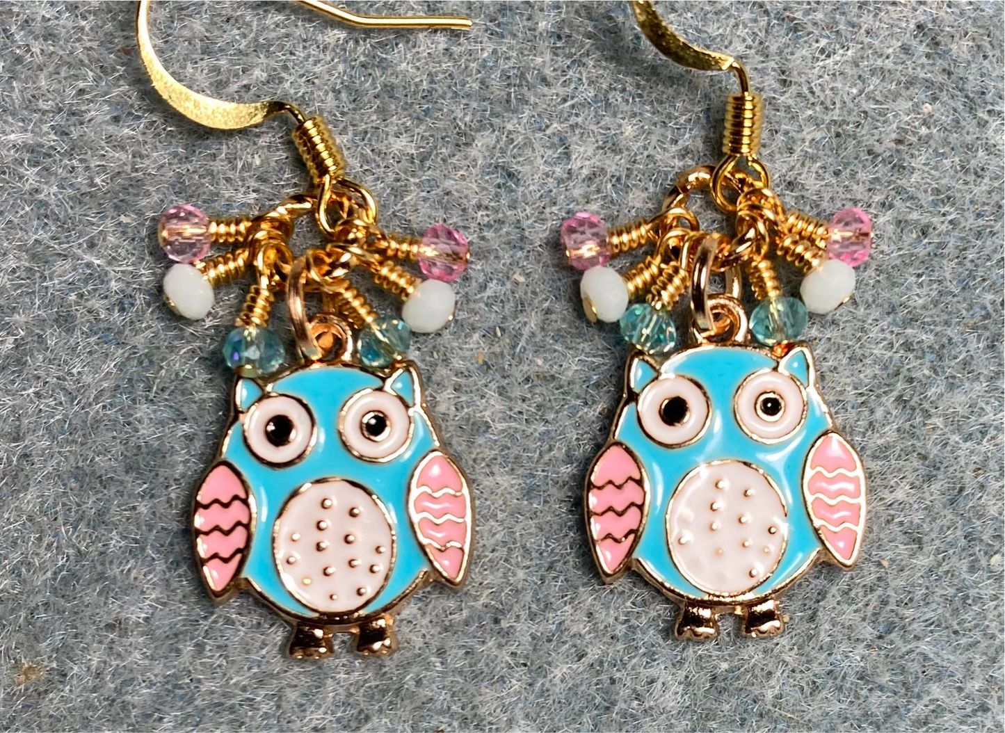 Small turquoise, pink, and white enamel owl charm earrings adorned with tiny dangling turquoise, pink, and white Chinese crystal beads.