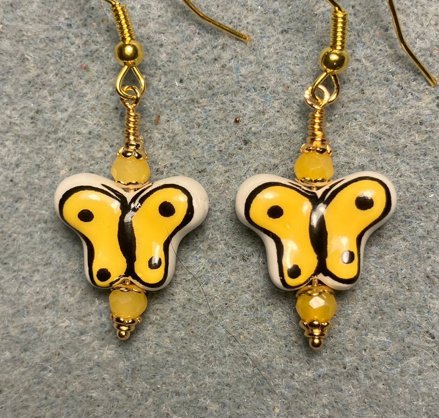 Yellow and black ceramic butterfly bead earrings adorned with yellow Chinese crystal beads.