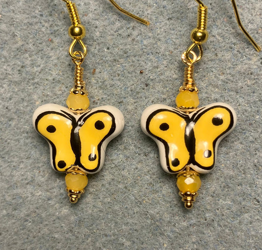 Yellow and black ceramic butterfly bead earrings adorned with yellow Chinese crystal beads.