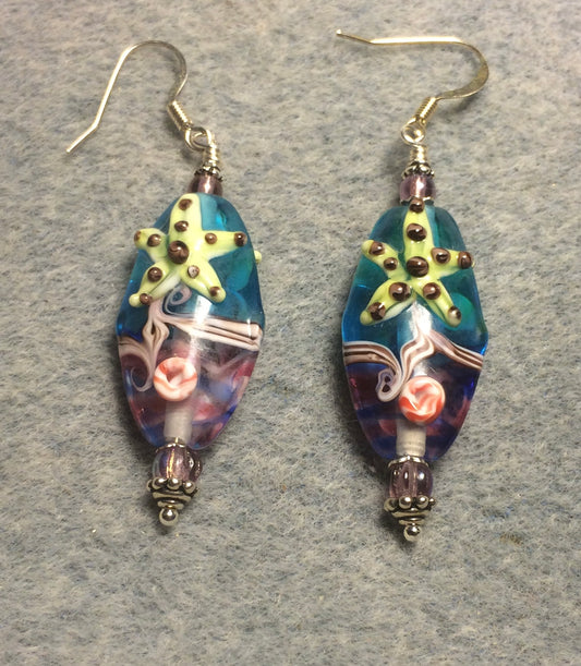 Lavender, turquoise, and green lamp work starfish bead earrings adorned with lavender Czech glass beads.