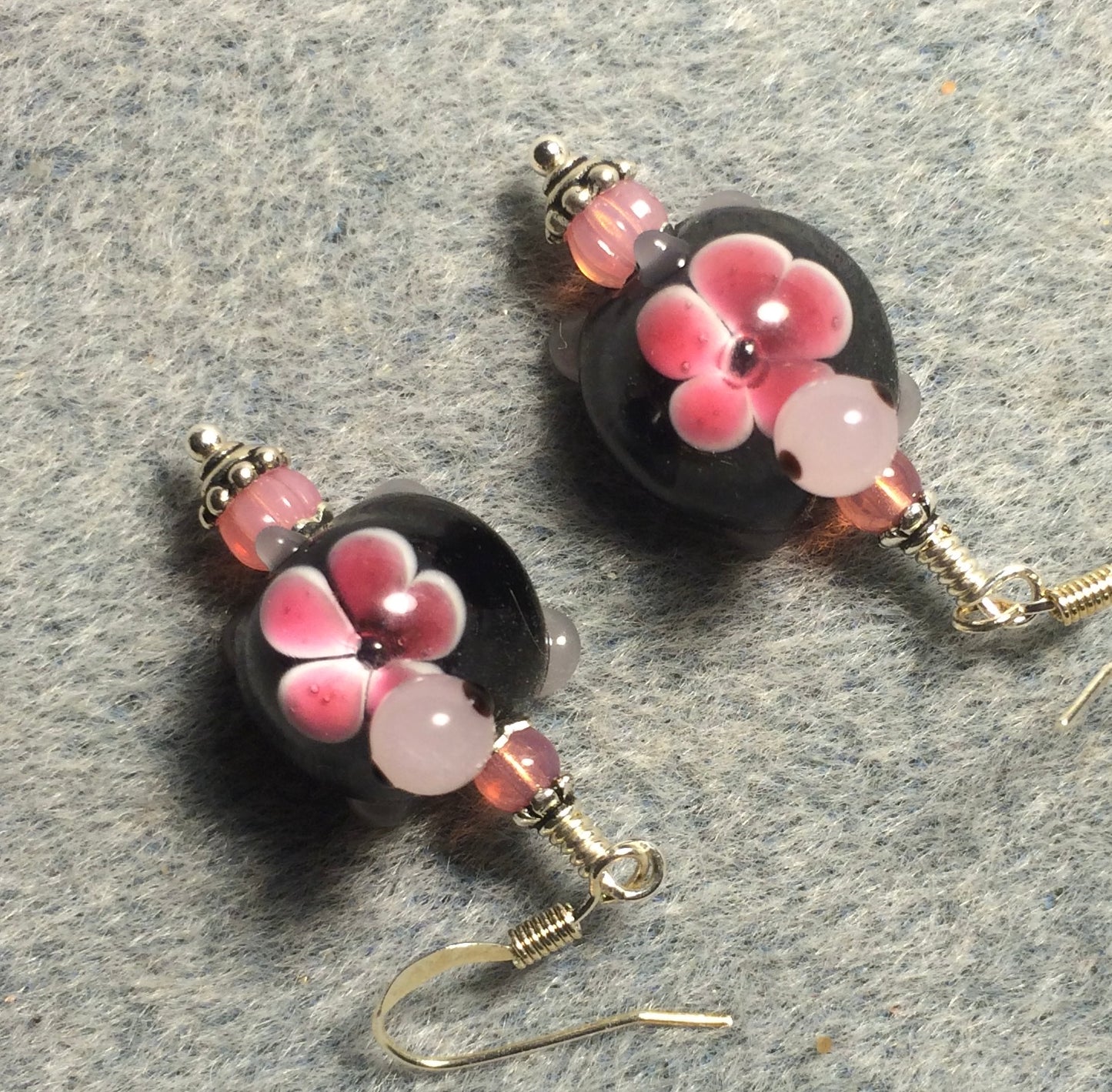 Black and pink lamp work turtle bead earrings adorned with pink Czech glass beads.