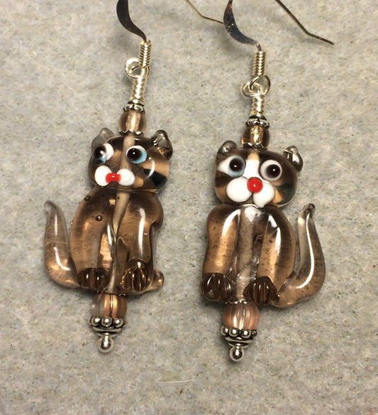 Translucent tan lamp work cat bead earrings adorned with tan Czech glass beads.