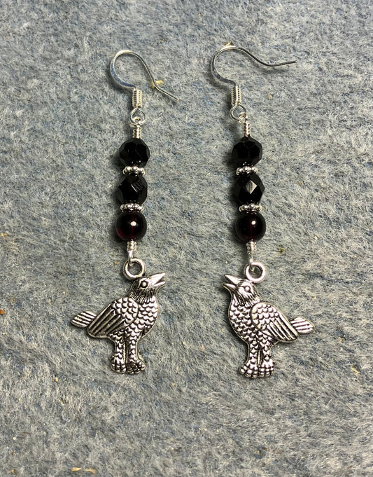 Silver raven charm earrings adorned with black Czech glass beads