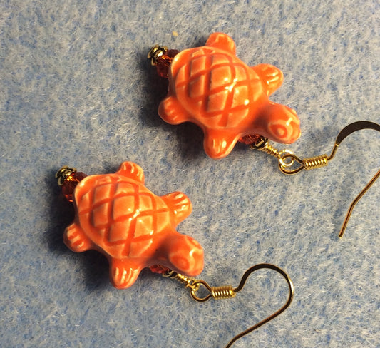 Orange ceramic turtle bead earrings adorned with orange Chinese crystal beads.