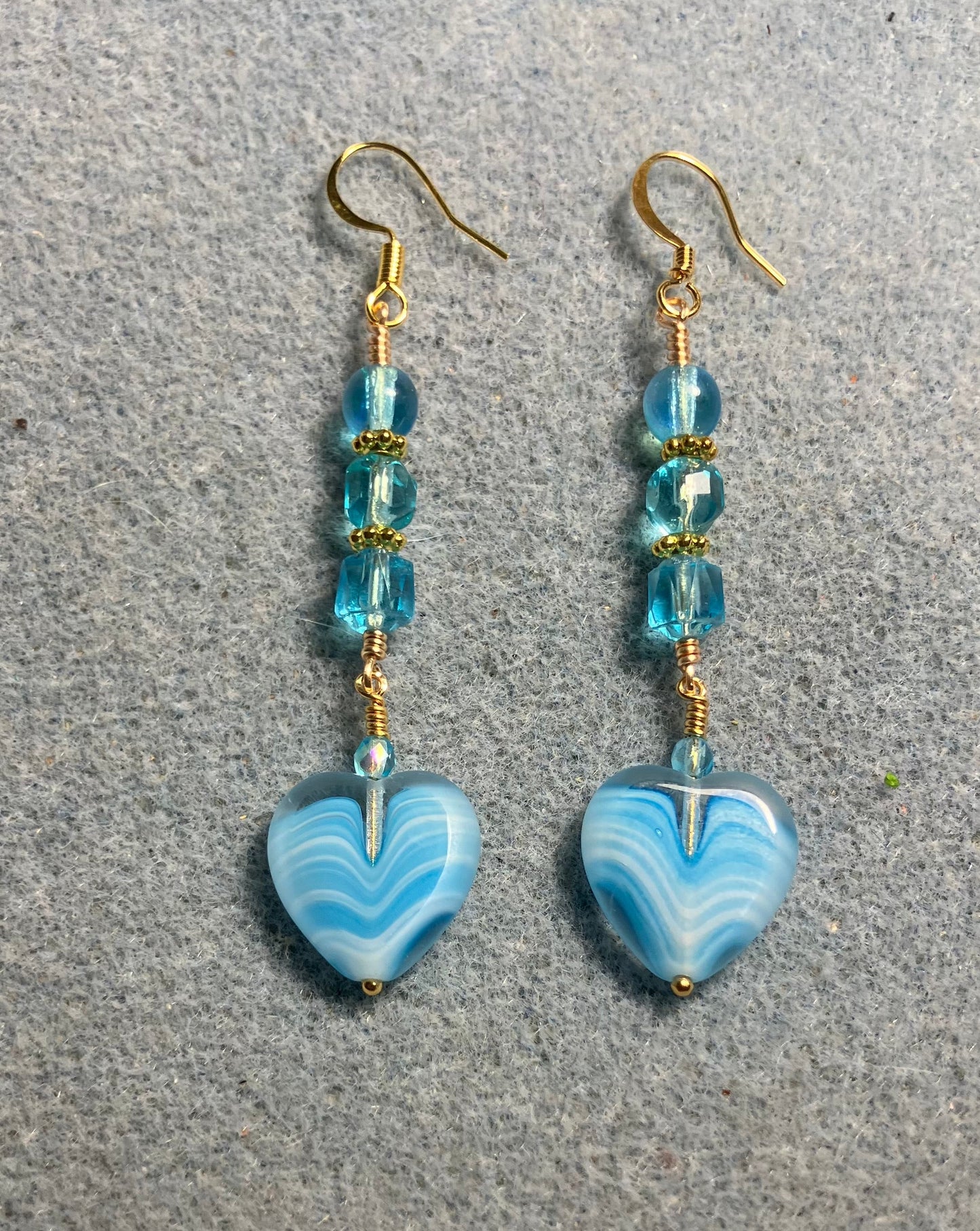 Turquoise Czech glass heart bead earrings adorned with turquoise Czech glass beads.