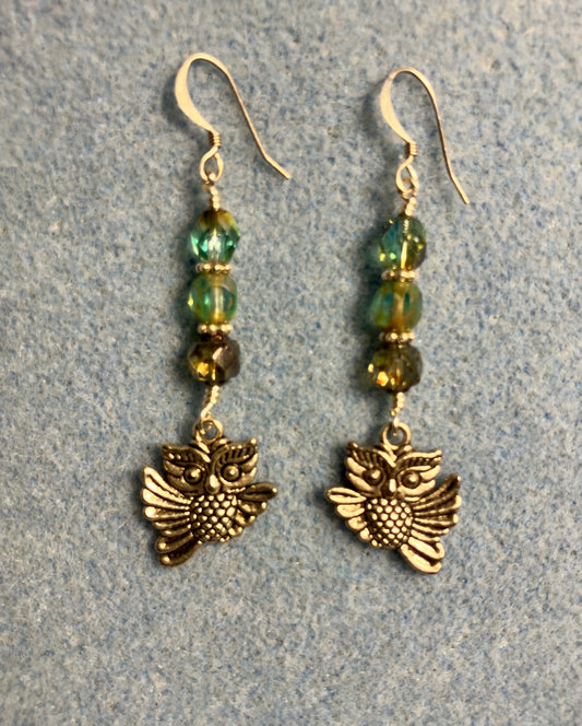 Silver owl charm earrings adorned with blue green Czech glass melon beads.