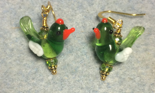 Translucent olive green and white lamp work songbird bead earrings adorned with olive green Chinese crystal beads.