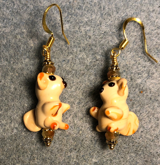 Small tan lamp work squirrel bead earrings adorned with tan Chinese crystal beads.