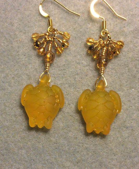 Amber sea glass sea turtle bead earrings adorned with amber Czech glass beads and small dangling amber Czech glass beads.