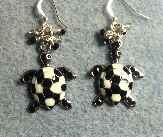 Large black and white enamel turtle charm earrings adorned with small dangling black and clear Czech glass beads.