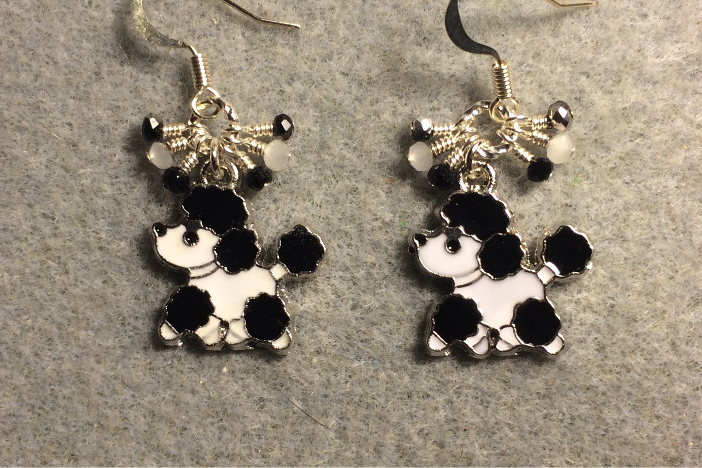 Black and white enamel poodle charm earrings adorned with tiny dangling black and white Chinese crystal beads.