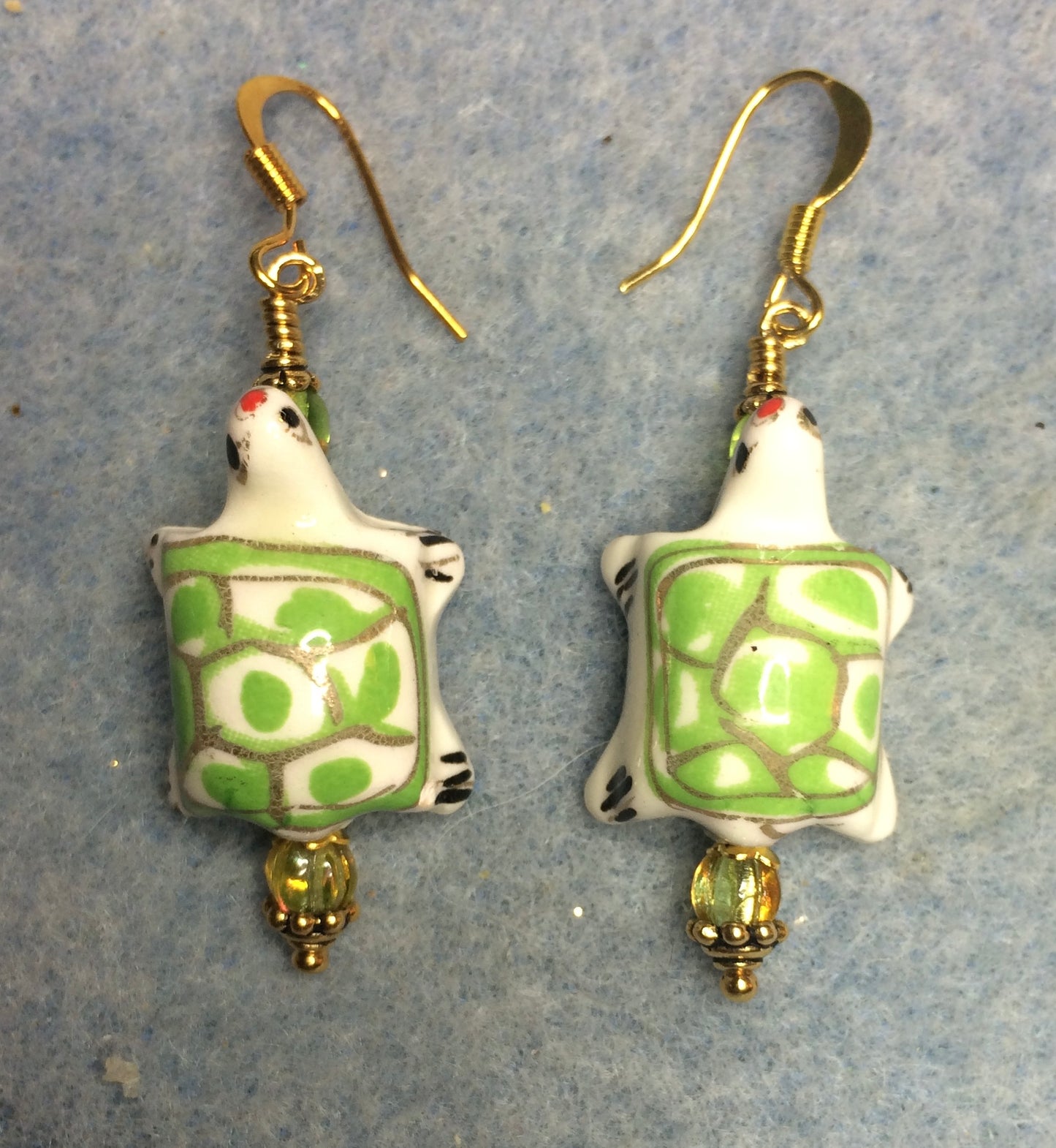 Lime green and white ceramic spotted turtle bead earrings adorned with lime green Czech glass beads.