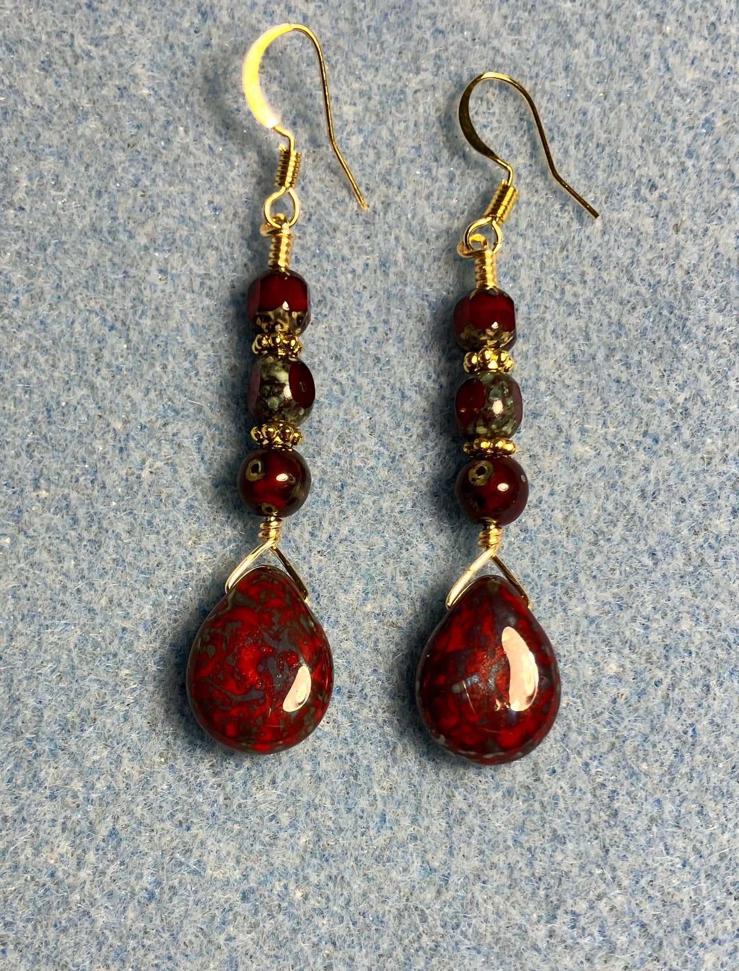 Dark red Picasso Czech glass pear drop bead earrings adorned with dark red Picasso Czech glass beads.