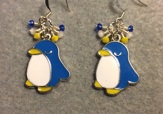 Blue, white, and yellow enamel penguin charm earrings adorned with tiny dangling blue, white, and yellow Chinese crystal beads.