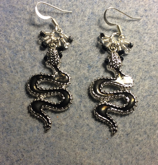 Black enamel coiled snake charm earrings adorned with tiny dangling black and silver Chinese crystal beads.
