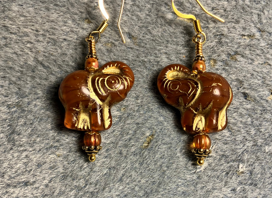 Orange (with gold inlay) Czech glass elephant bead earrings adorned with orange Czech glass beads.