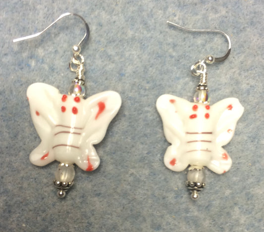 White lamp work butterfly bead earrings adorned with clear Czech glass beads.