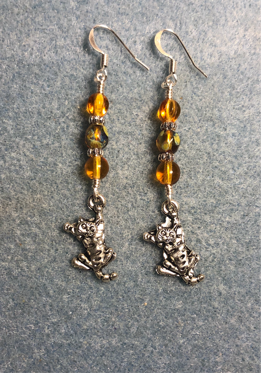 Silver tabby cat charm earrings adorned with amber Czech glass beads.