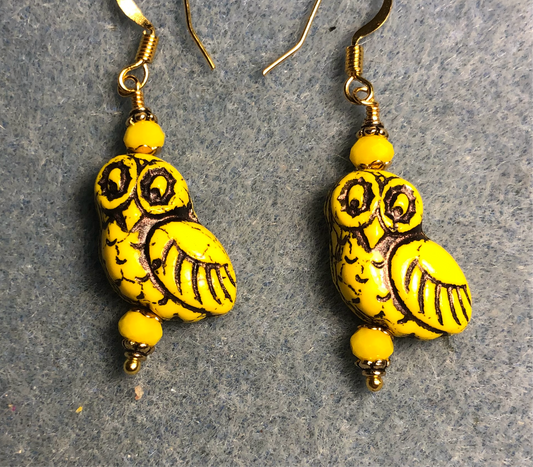 Opaque yellow (with black wash) fancy Czech glass owl bead earrings adorned with yellow Chinese crystal beads.
