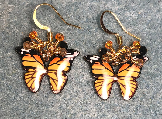 Orange and black enamel butterfly charm earrings adorned with tiny dangling orange and black Chinese crystal beads.