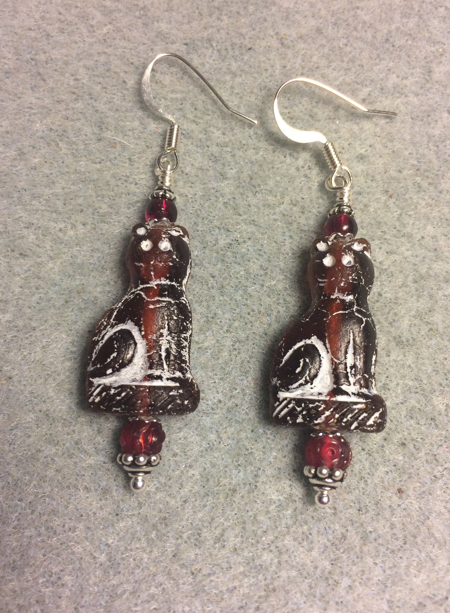 Dark red (with white inlay) fancy Czech glass cat bead earrings adorned with dark red Czech glass beads.