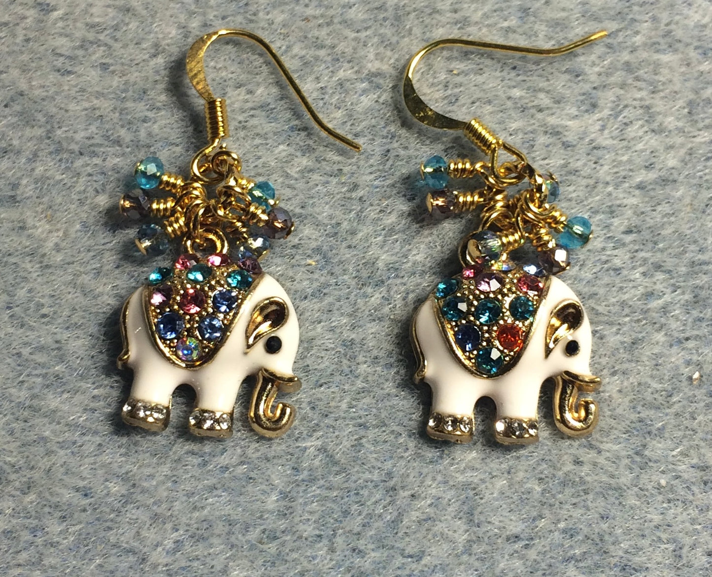 White enamel and colorful rhinestone elephant charm earrings adorned with tiny dangling blue, purple, and aqua Chinese crystal beads.