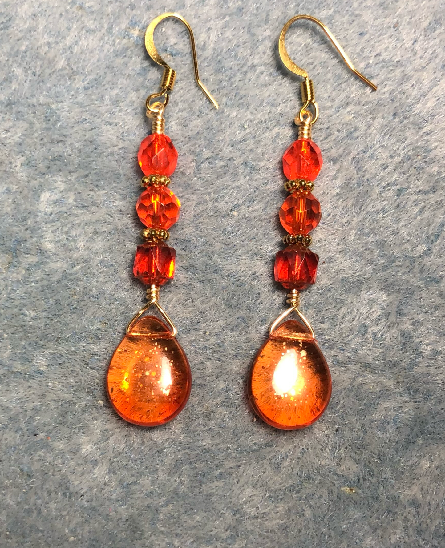 Orange gold dust Czech glass pear drop bead earrings adorned with orange Czech glass beads.