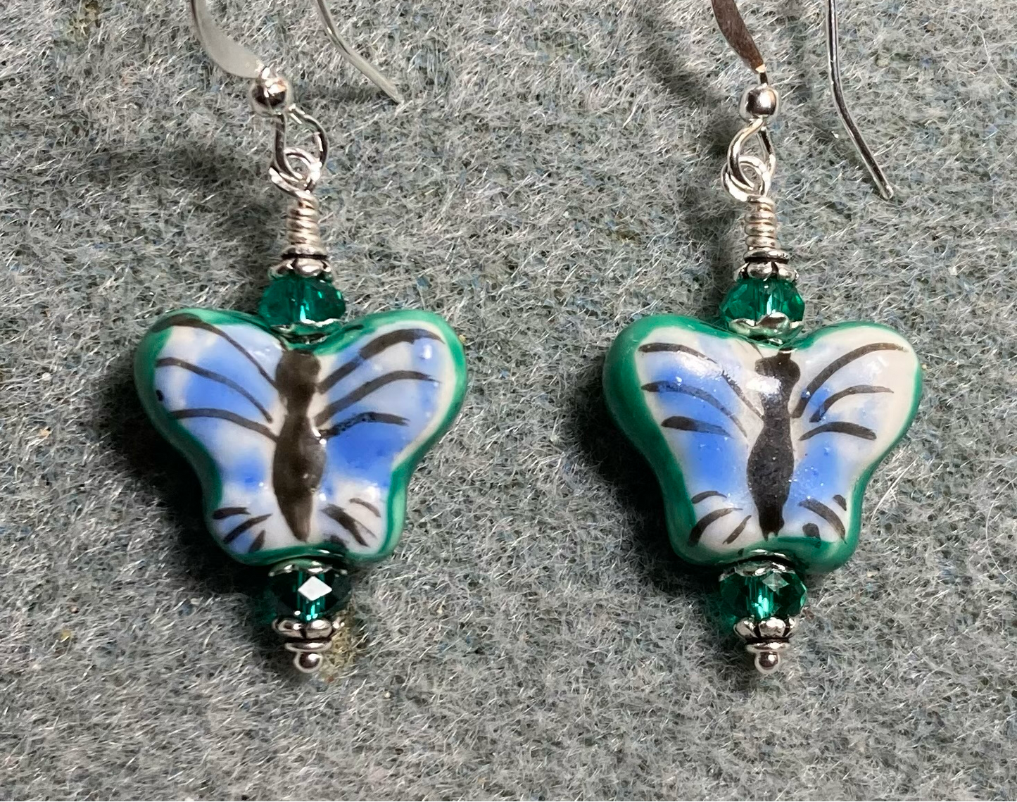 Blue and teal ceramic butterfly bead earrings adorned with teal Chinese crystal beads.