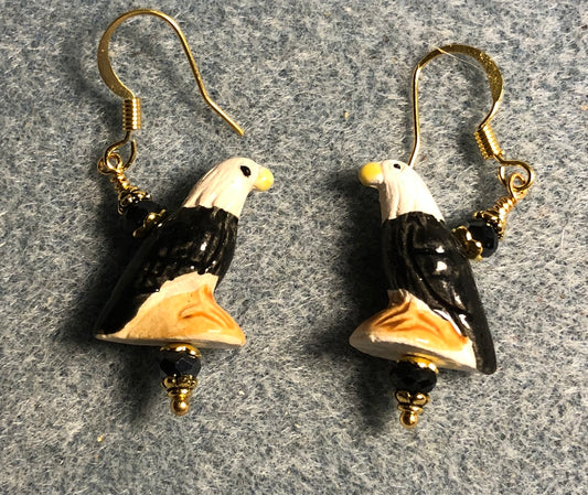 Small black, tan, and white ceramic eagle bead earrings adorned with black Chinese crystal beads.