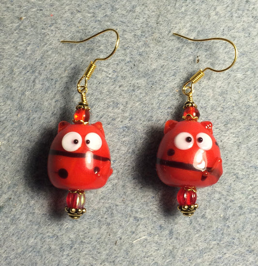 Small opaque red lamp work mischievous cat bead earrings adorned with red Czech glass beads.