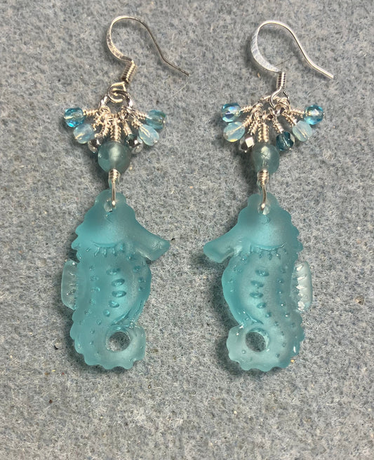 Light turquoise sea glass seahorse pendant bead earrings adorned with light turquoise Czech glass beads and small dangling turquoise Czech glass beads.