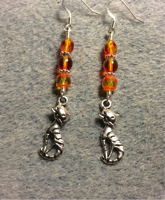 Silver cat charm earrings adorned with orange yellow Czech glass beads
