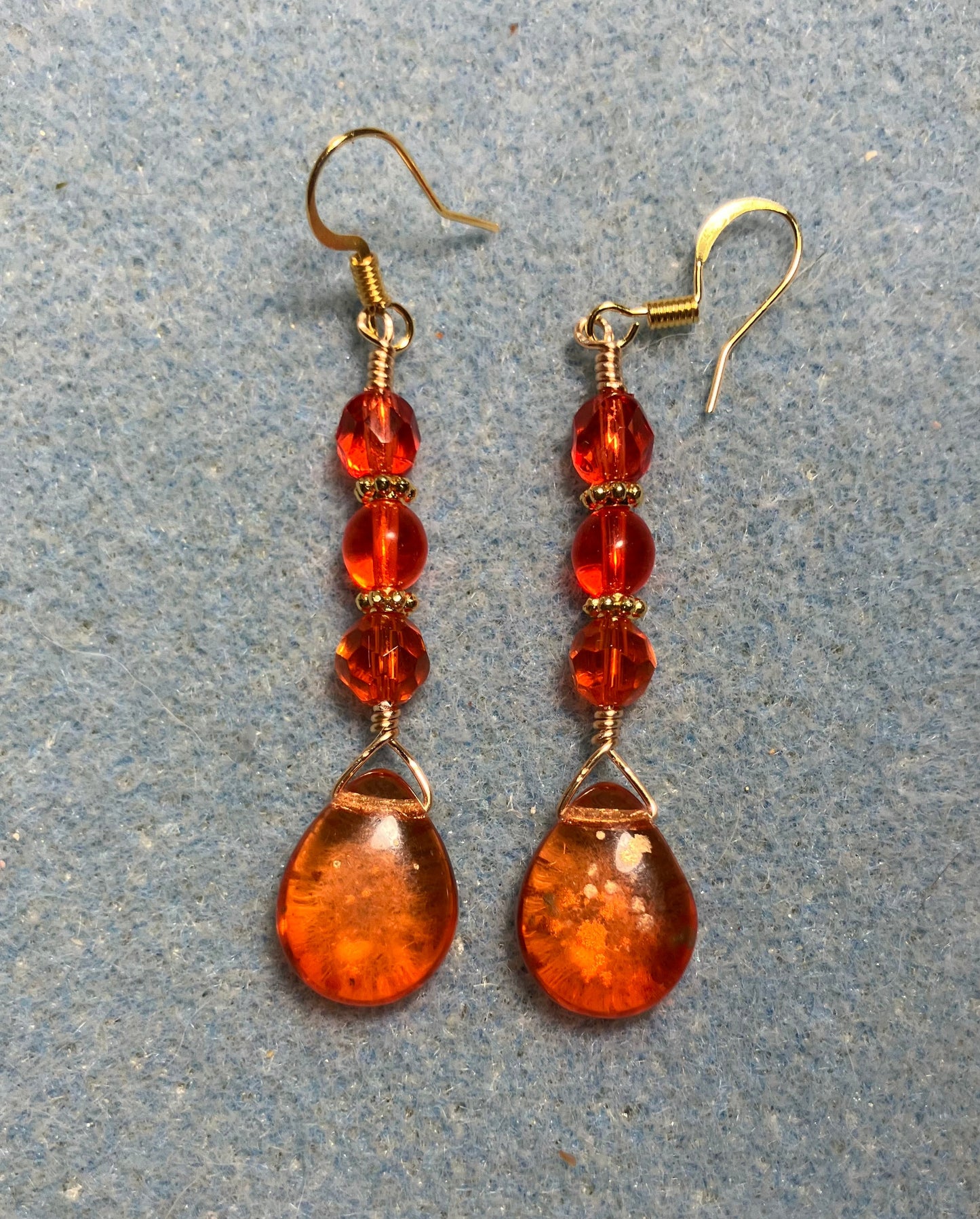 Orange gold dust Czech glass pear drop bead earrings adorned with orange Czech glass beads.