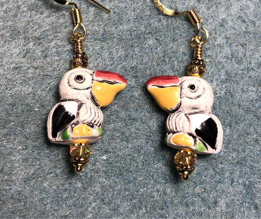 Small tan, amber, and red ceramic pelican bead earrings adorned with amber Chinese crystal beads.