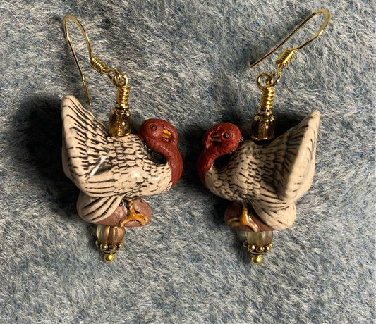 Tan and red ceramic turkey bead earrings adorned with tan Czech glass beads.