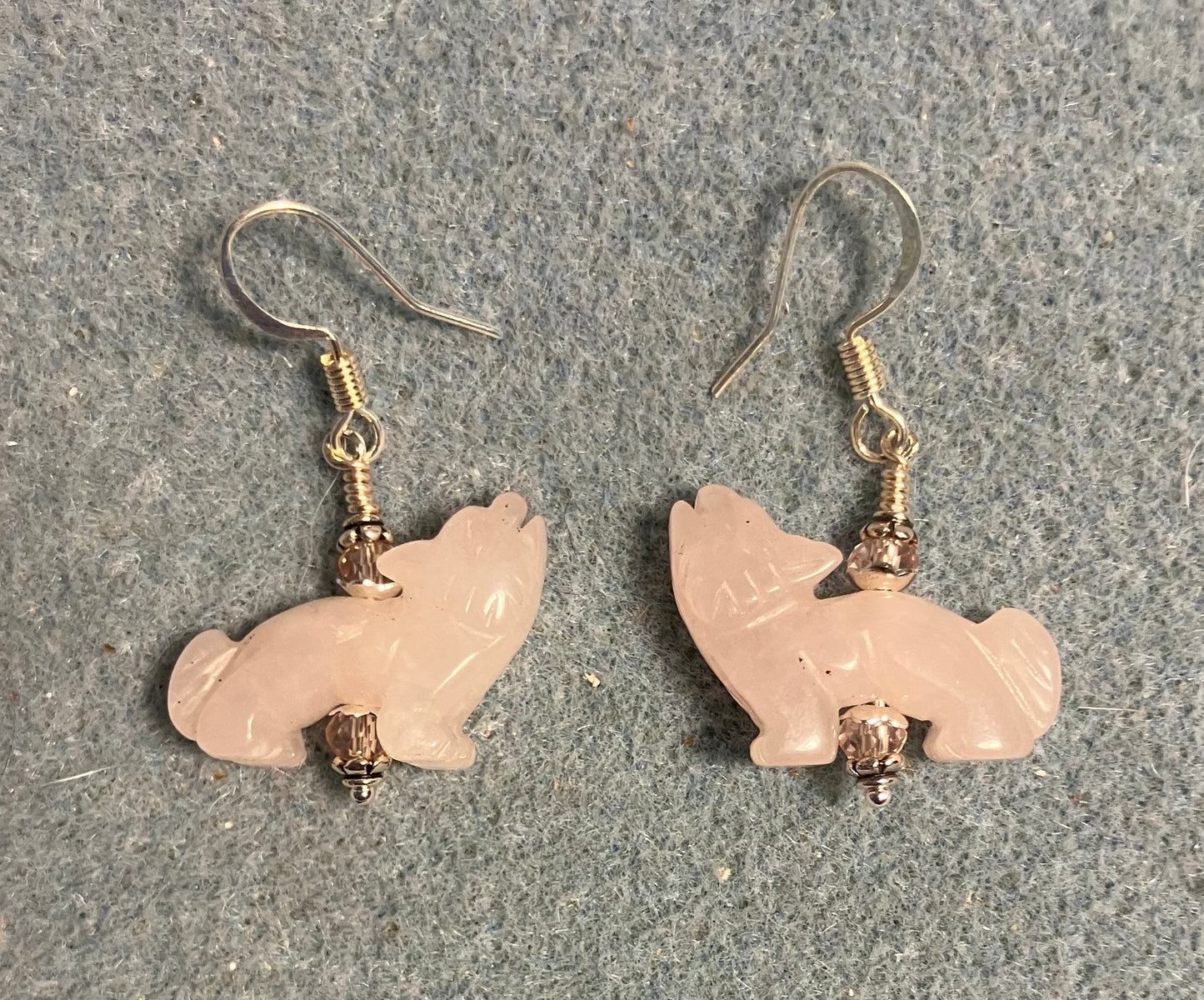 Pink quartz gemstone howling coyote bead earrings adorned with pink Chinese crystal beads.