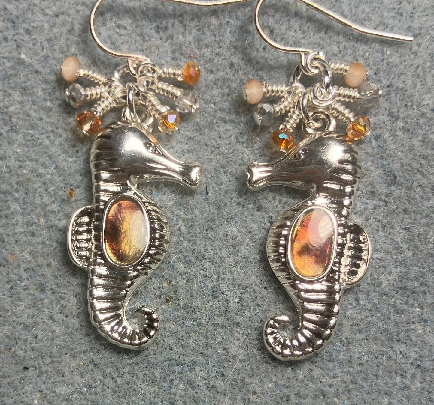 Silver and peach brown abalone seahorse charm earrings adorned with tiny dangling peach and silver Chinese crystal beads.