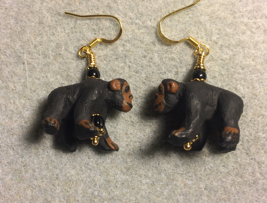 Large black and brown ceramic chimpanzee bead earrings adorned with black Czech glass beads.