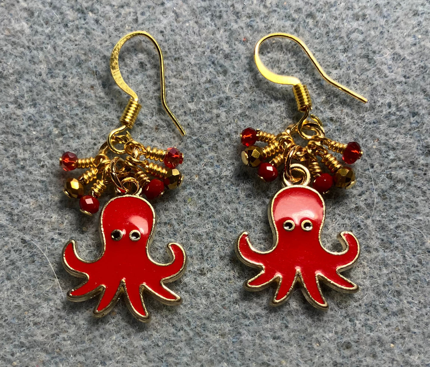 Red and gold enamel octopus charm earrings adorned with tiny dangling red and gold Chinese crystal beads.