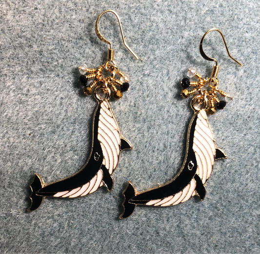 Long black and white enamel whale charm earrings adorned with tiny dangling black, white, and gold Chinese crystal beads.