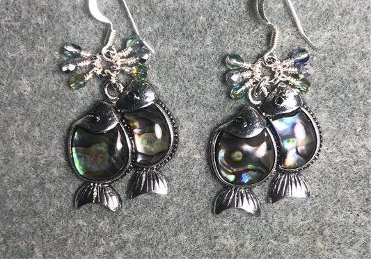 Silver and abalone fish charm earrings adorned with small dangling green, silver, and purple Czech glass beads.