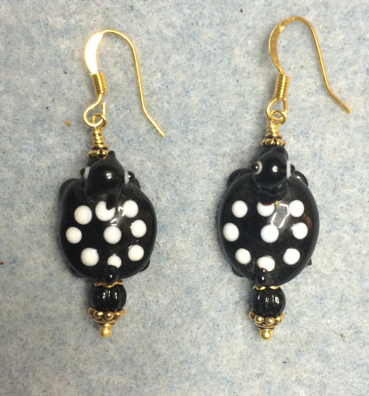 Black and white lamp work spotted turtle bead earrings adorned with black Czech glass beads.