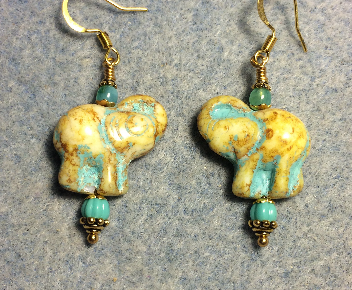 Yellow beige (with turquoise inlay) Czech glass elephant bead earrings adorned with turquoise Czech glass beads.