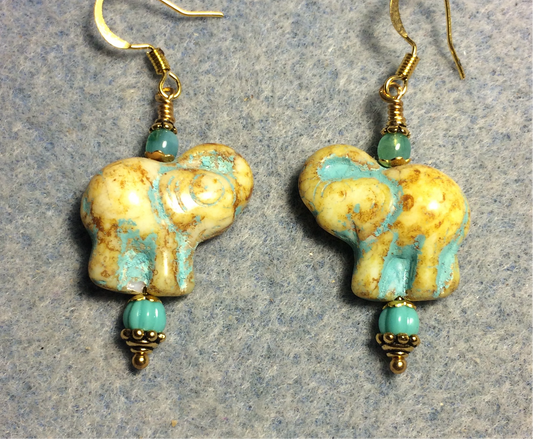 Yellow beige (with turquoise inlay) Czech glass elephant bead earrings adorned with turquoise Czech glass beads.