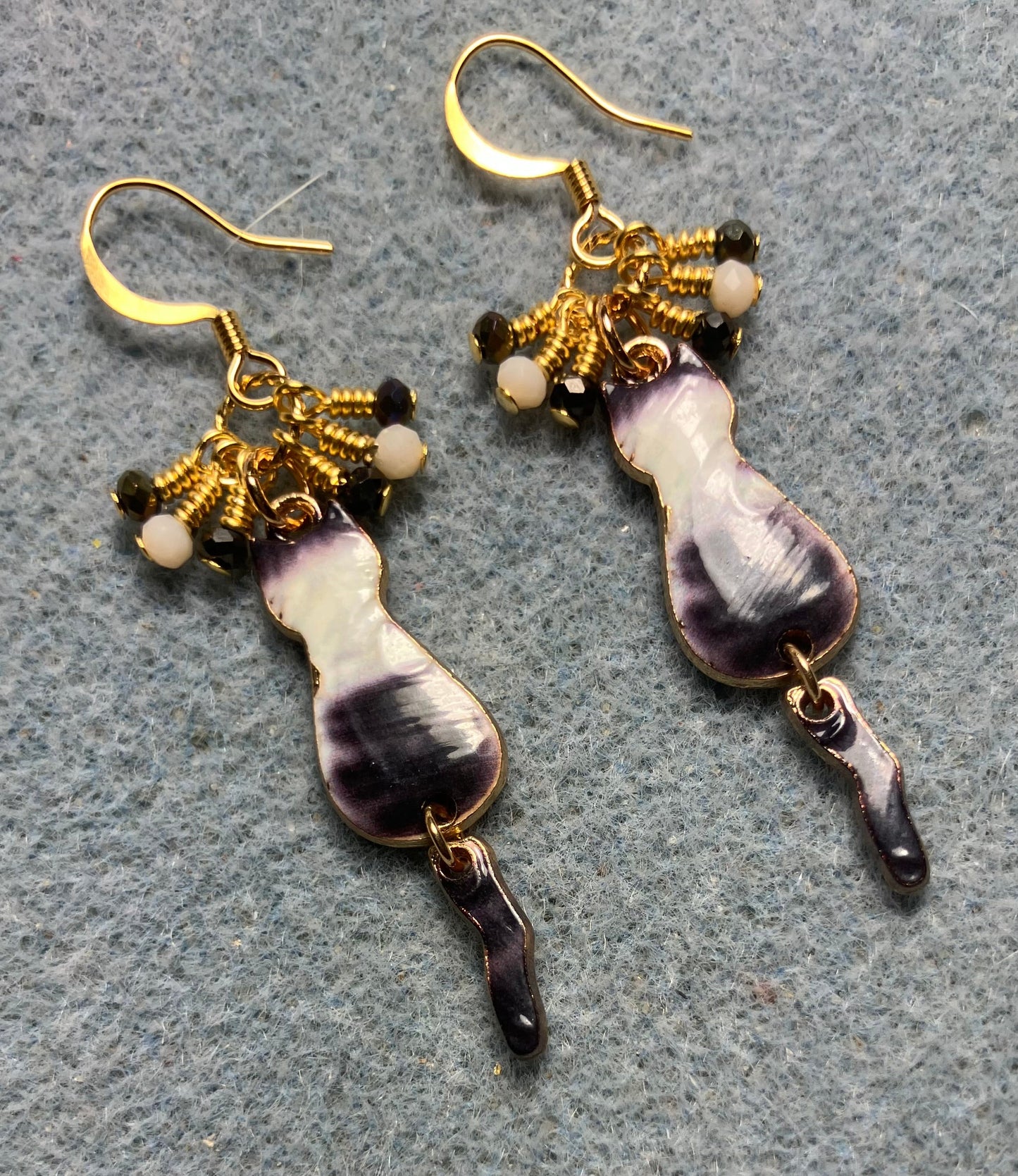 Gray and white enamel cat charm earrings adorned with tiny dangling gray and white Chinese crystal beads.