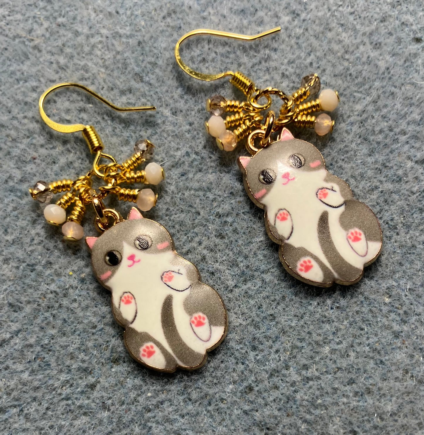 Tan, white, and peach enamel cat charm earrings adorned with tiny dangling tan, white, and peach Chinese crystal beads.