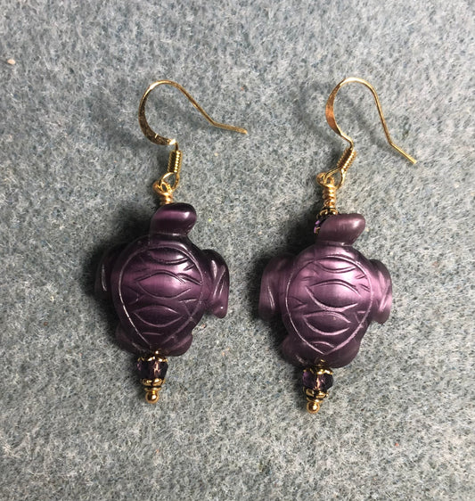 Purple fiber optic (cat’s eye) turtle bead earrings adorned with purple Chinese crystal beads.